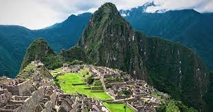A vibrant view of Machu Picchu surrounded by lush green mountains during February
