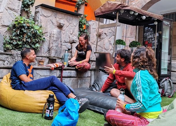 Solo traveler connecting with others in a lively hostel environment in Latin America.